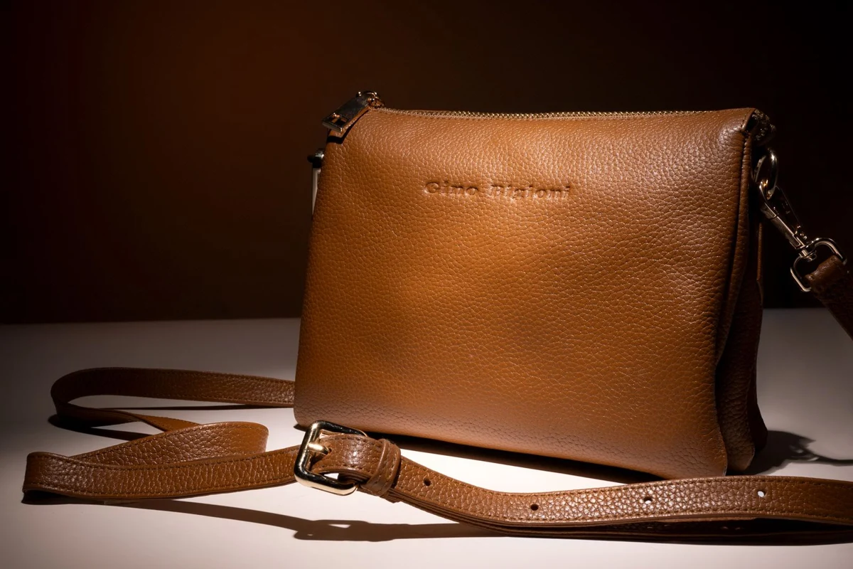 A brown crossbody bag with adjustable shoulder strap
