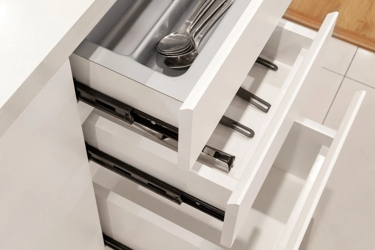 A divided drawer holding kitchen utensils