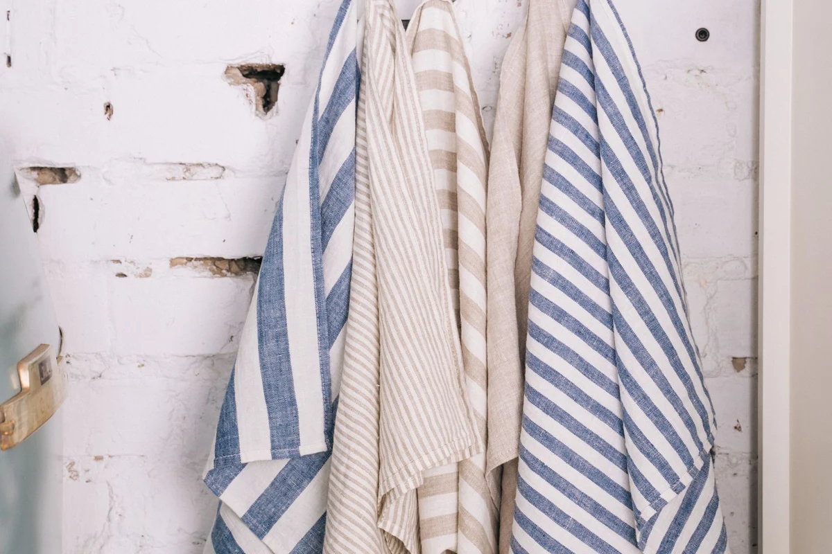 Striped kitchen towels hanging from hooks