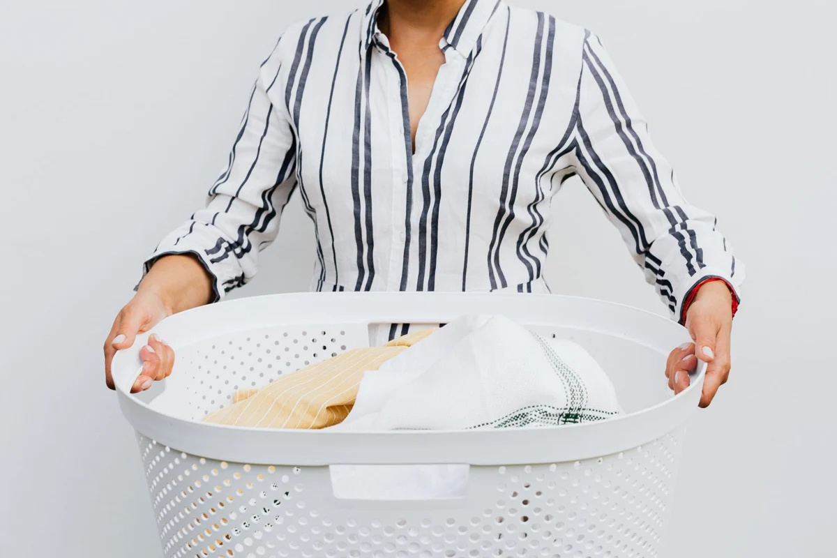 A person carrying a laundry basket