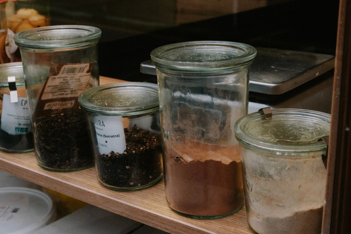 Glass spice jars arranged along a shelf
