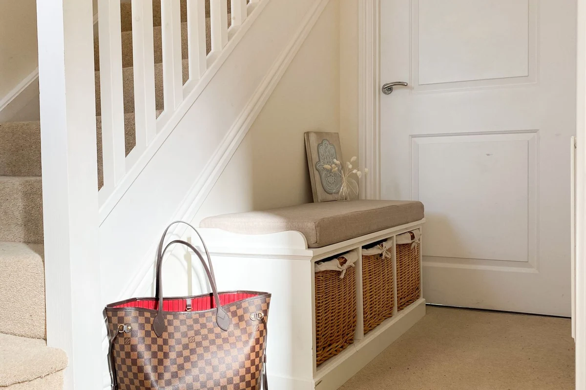 A bench with baskets stored beneath its seat
