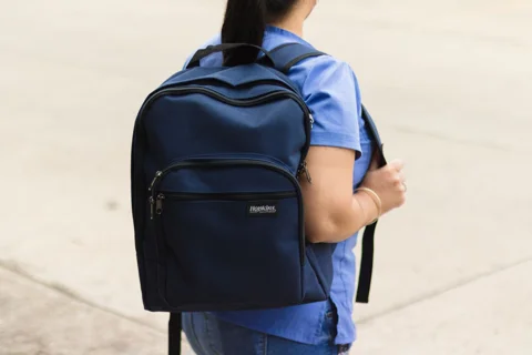 A person wearing a backpack with adjustable straps