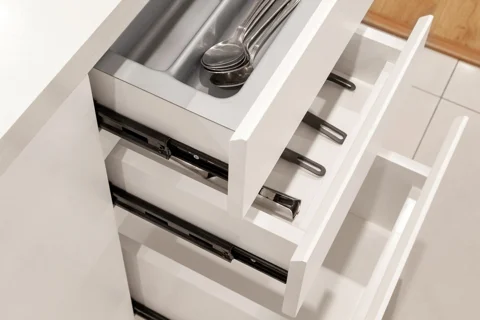 A divided drawer holding kitchen utensils