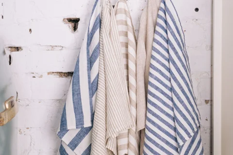 Striped kitchen towels hanging from hooks