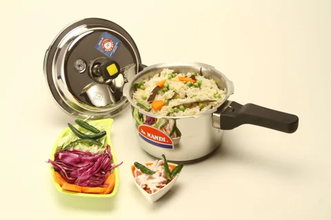 A pressure cooker containing vegetable rice