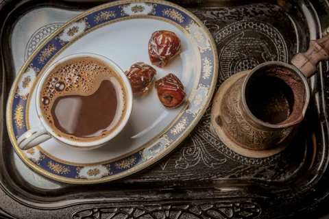 A tray holding cups and dates