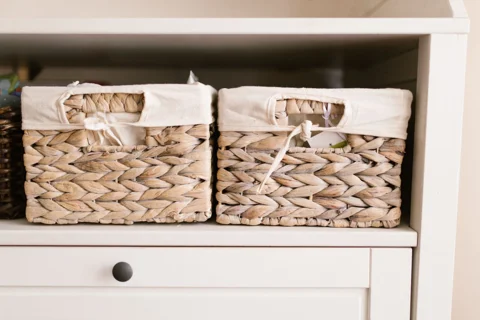 Woven storage baskets fitted onto a shelf