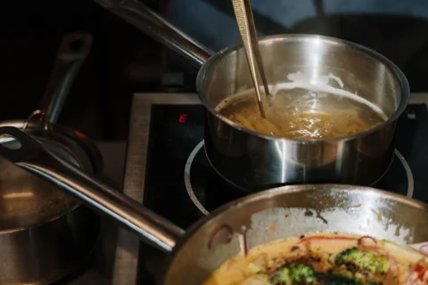 Stainless steel cookware on a hob