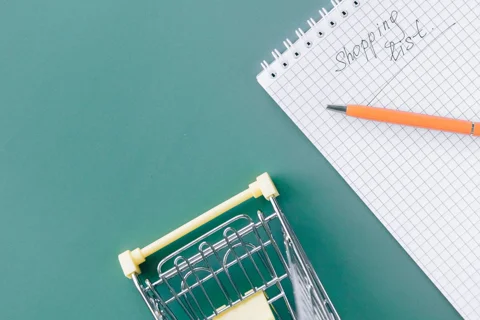 A shopping list written in a spiral notebook
